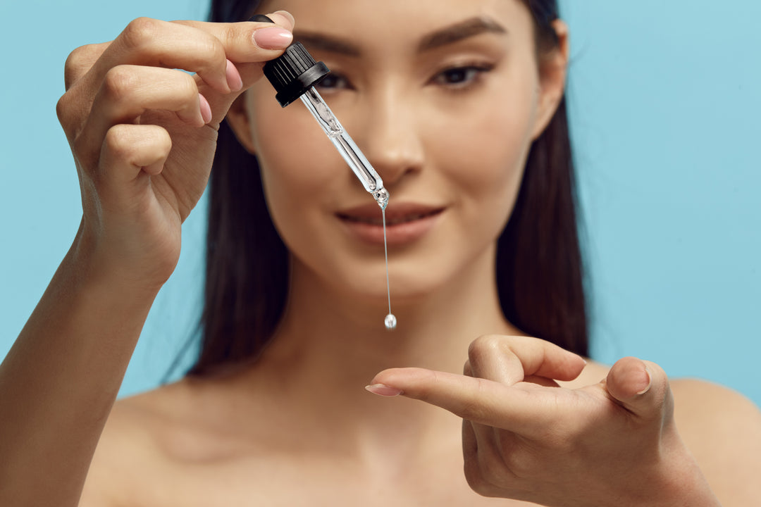 Asian woman applying serum to her finger