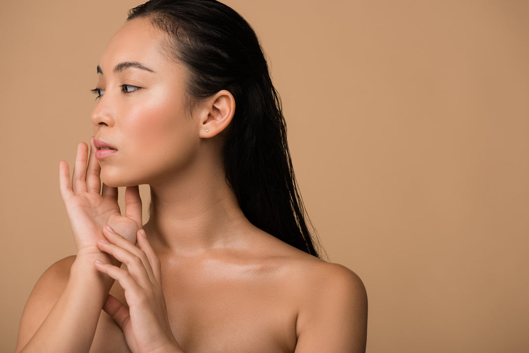 Closeup of an Asian woman touching her face