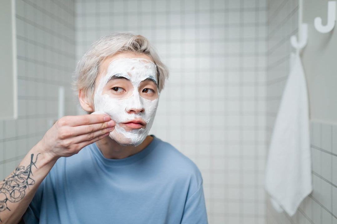 A man applying cream to his face